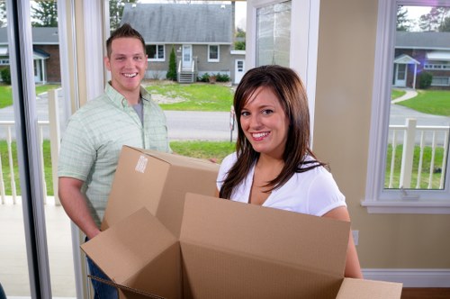 Happy customers with their belongings after a Durack move